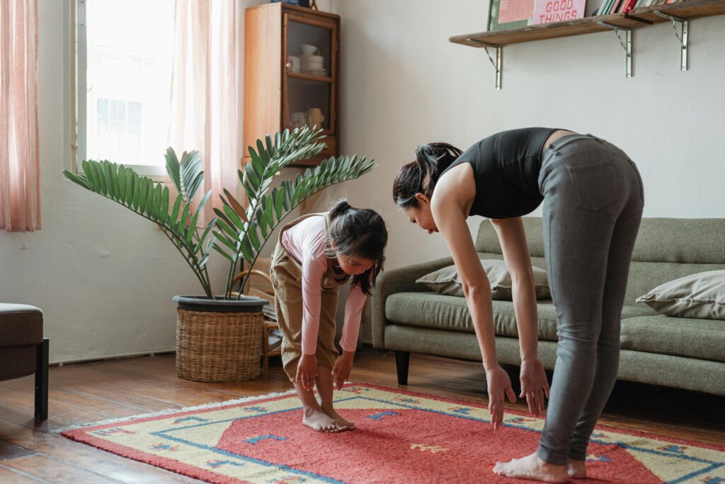 Woman doing lower back and hip stretches for morning pain relief.
